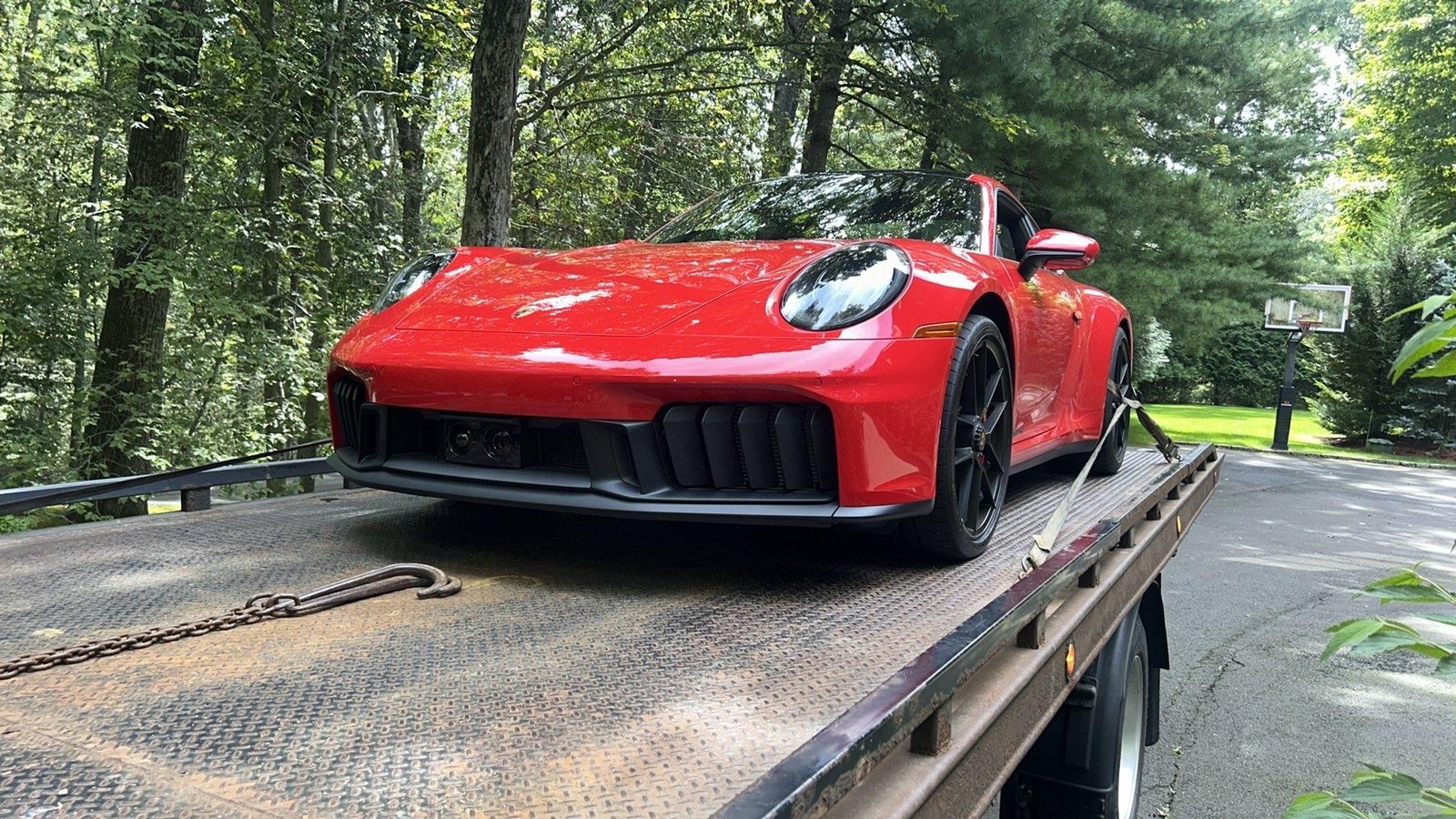 Red sports car on an AG flatbed