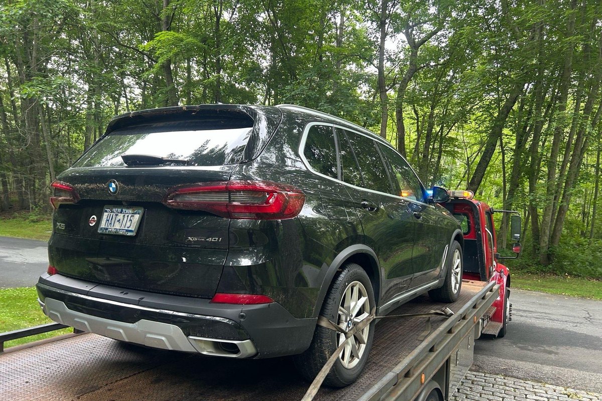 SUV strapped on a red flatbed