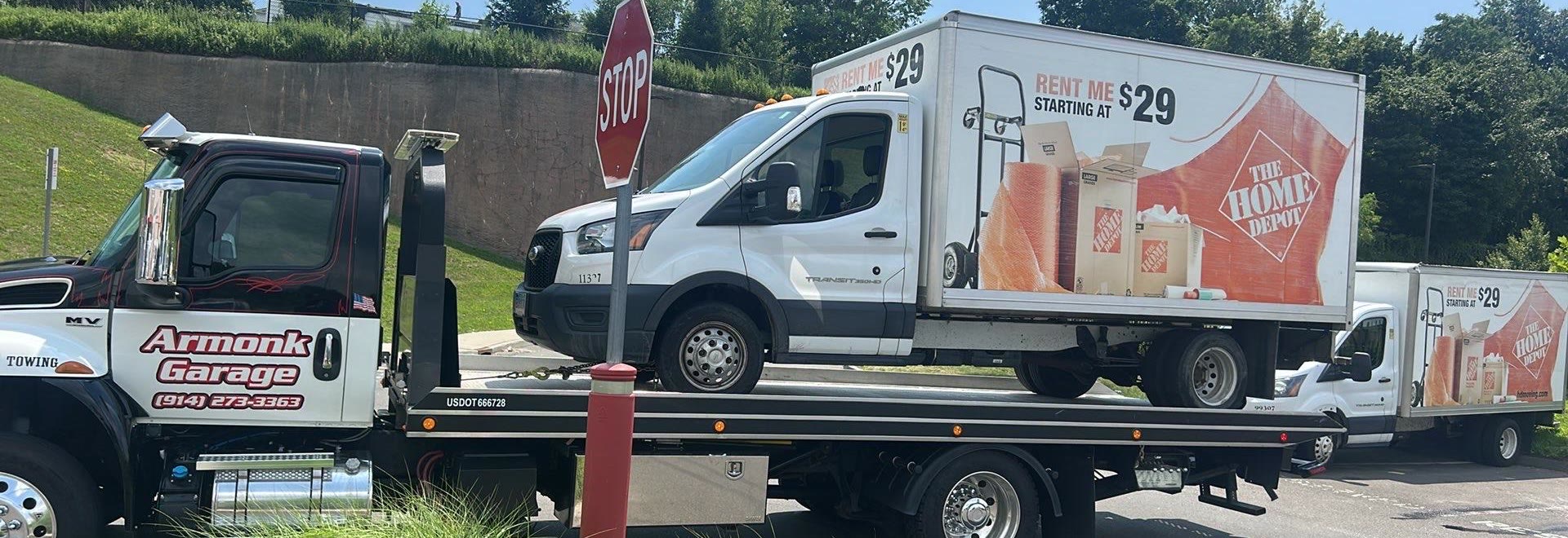 AG Towing flatbed carrying a box truck
